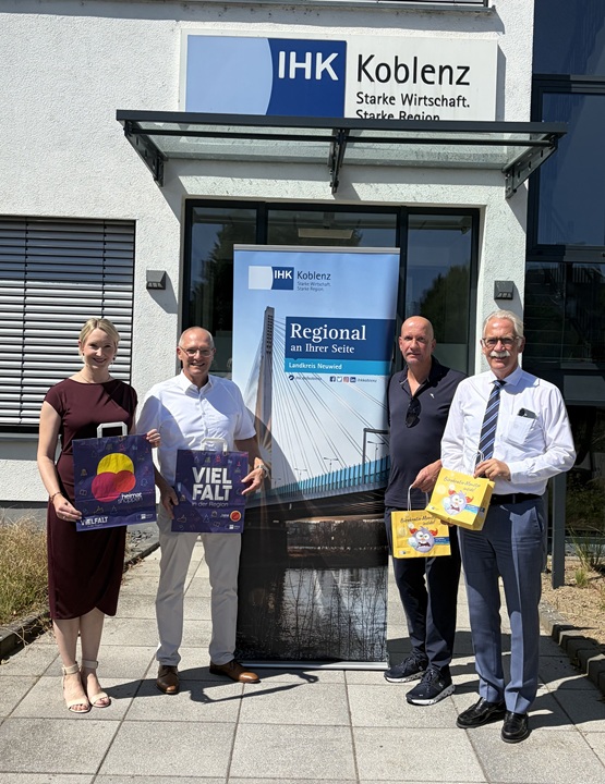 4 Personen stehen vor der Eingang mit Rollup "Regional an Ihrer Seite"