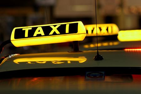 Mehrere Taxischilder leuchten auf Autod&auml;chern.