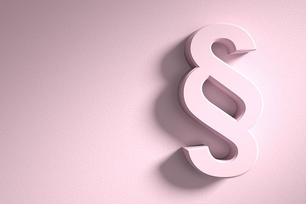 ZU sehen ist ein Paragraf, der sich reliefartig vom rosa Hintergrund abhebt.
