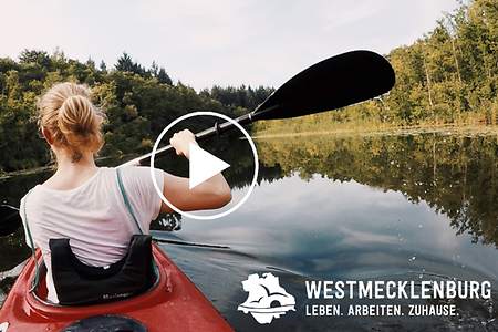 Frau in einem Padelboot auf einem Fluss paddelnd