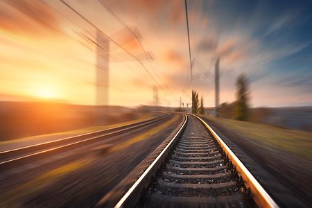 Railroad,In,Motion,At,Sunset.,Railway,Station,With,Motion,Blur