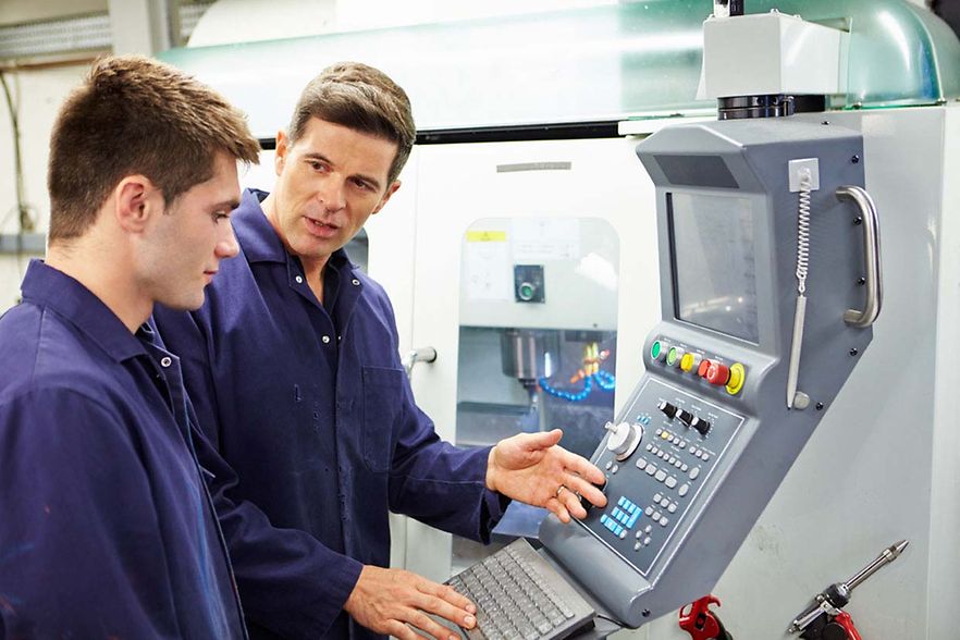 Engineer,And,Apprentice,Using,Automated,Milling,Machine