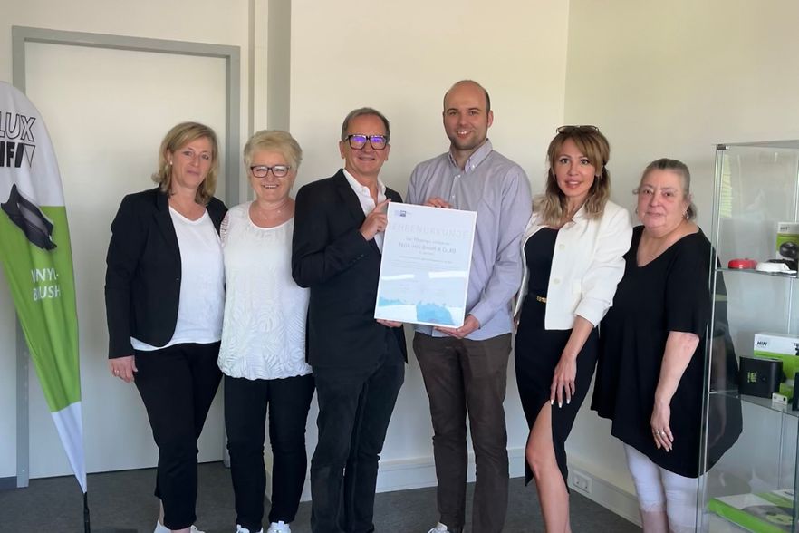 IHK-Referent Rafael Pekmezovic &uuml;bergibt Dr. Gartner und seinem Team die Jubil&auml;umsurkunde