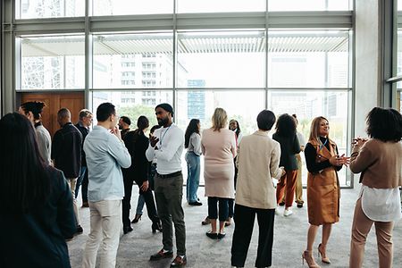 Corporate crowd engaging in teamwork during business event in modern office space