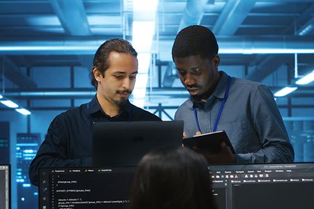 Diverse team of admins supervising data center supercomputers