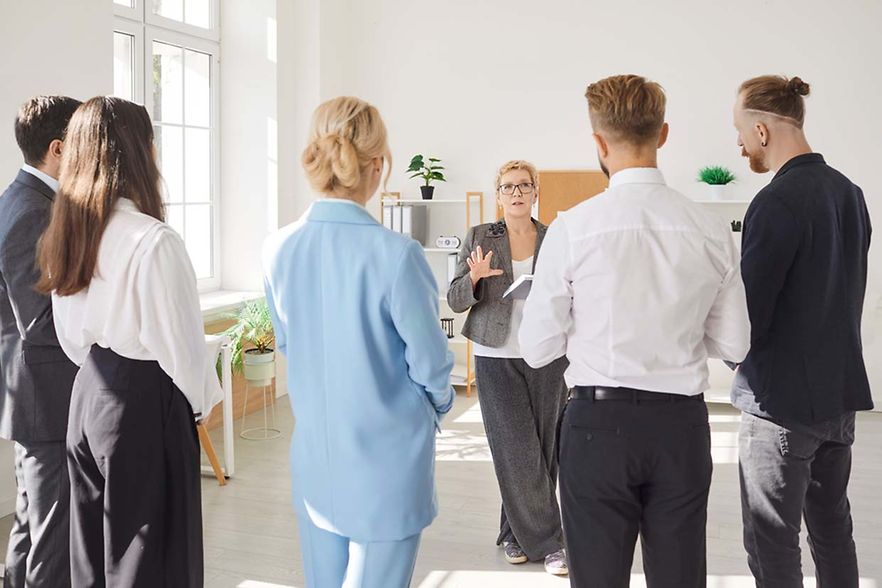 Back,View,Of,Diverse,Group,Of,Company,Employees,Standing,In