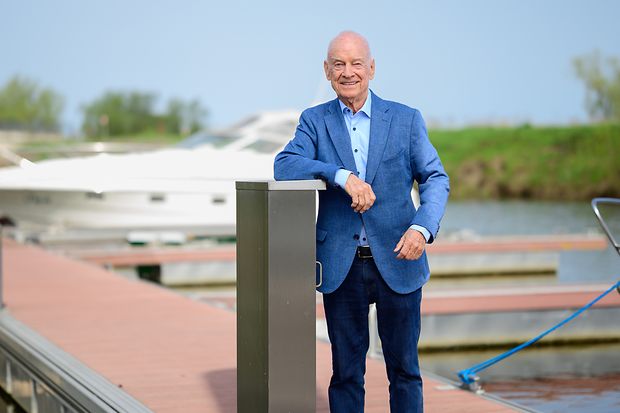 Peter Schneeberg steht auf dem Steg, im Hintergrund ist ein Sportboot zu sehen.