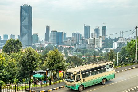 Сentral business district with modern downtown skyscrapers and passenger bus on the road, Addis Ababa, Ethiopia