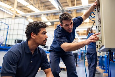 Zwei M&auml;nner reparieren etwas 
