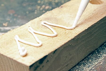 putting glue on a piece of wood