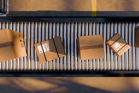 Packages on roller conveyor in warehouse distribution center ready for shipping and logistics processing